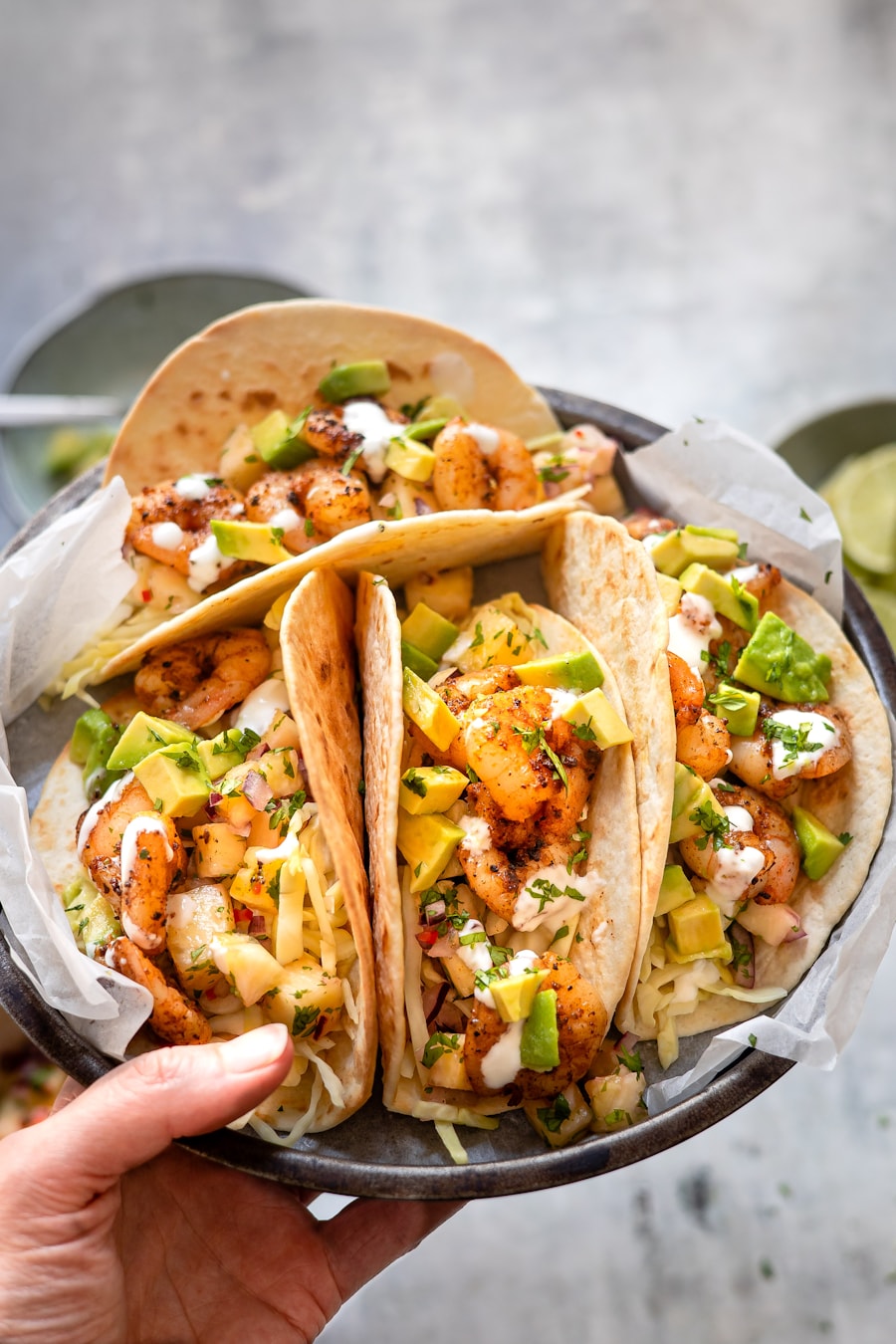 Colorful vegetarian tacos with avocado, herbs, and lime